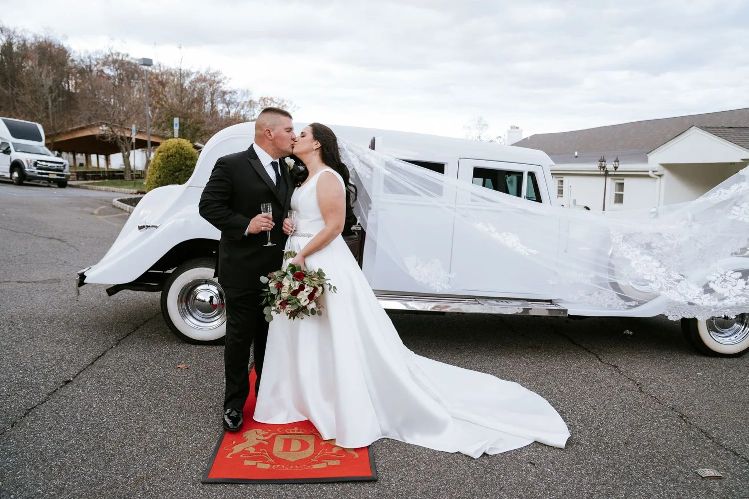 Newlyweds kissing beside a white vintage limousine — Maximus Visions photography services, weddings and family portraits in New Jersey and New York City