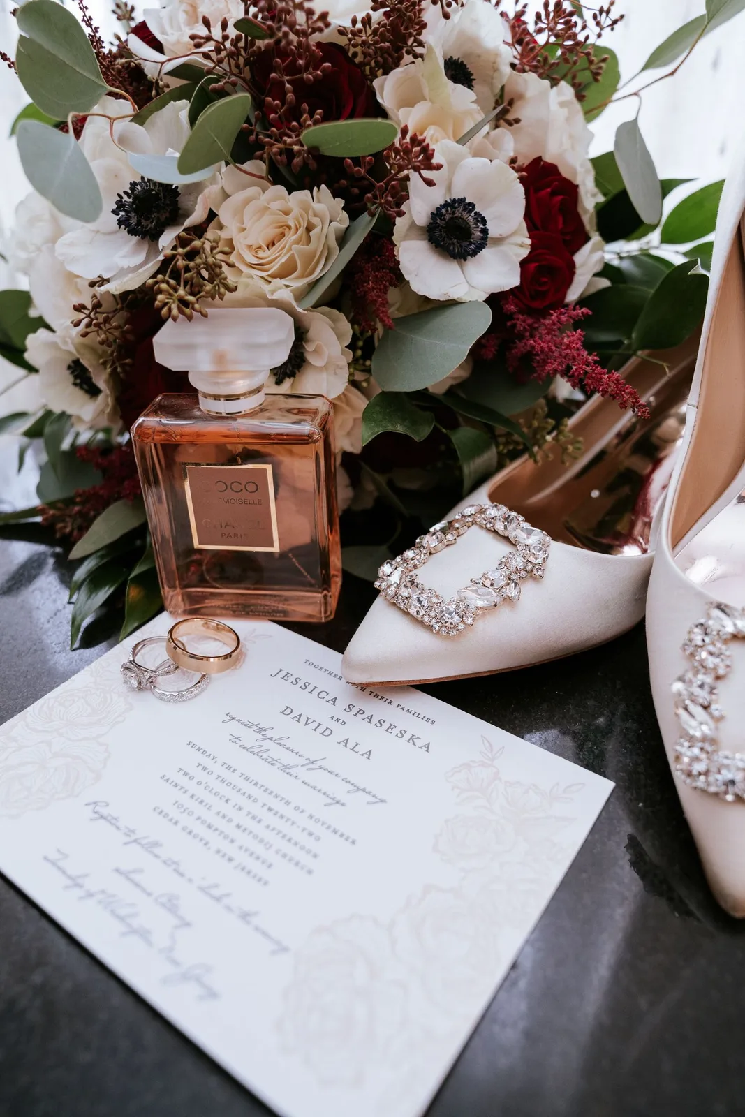Wedding-day flat lay with bouquet, perfume, rings, invitation and bridal heels — Maximus Visions wedding photography, New Jersey & New York City