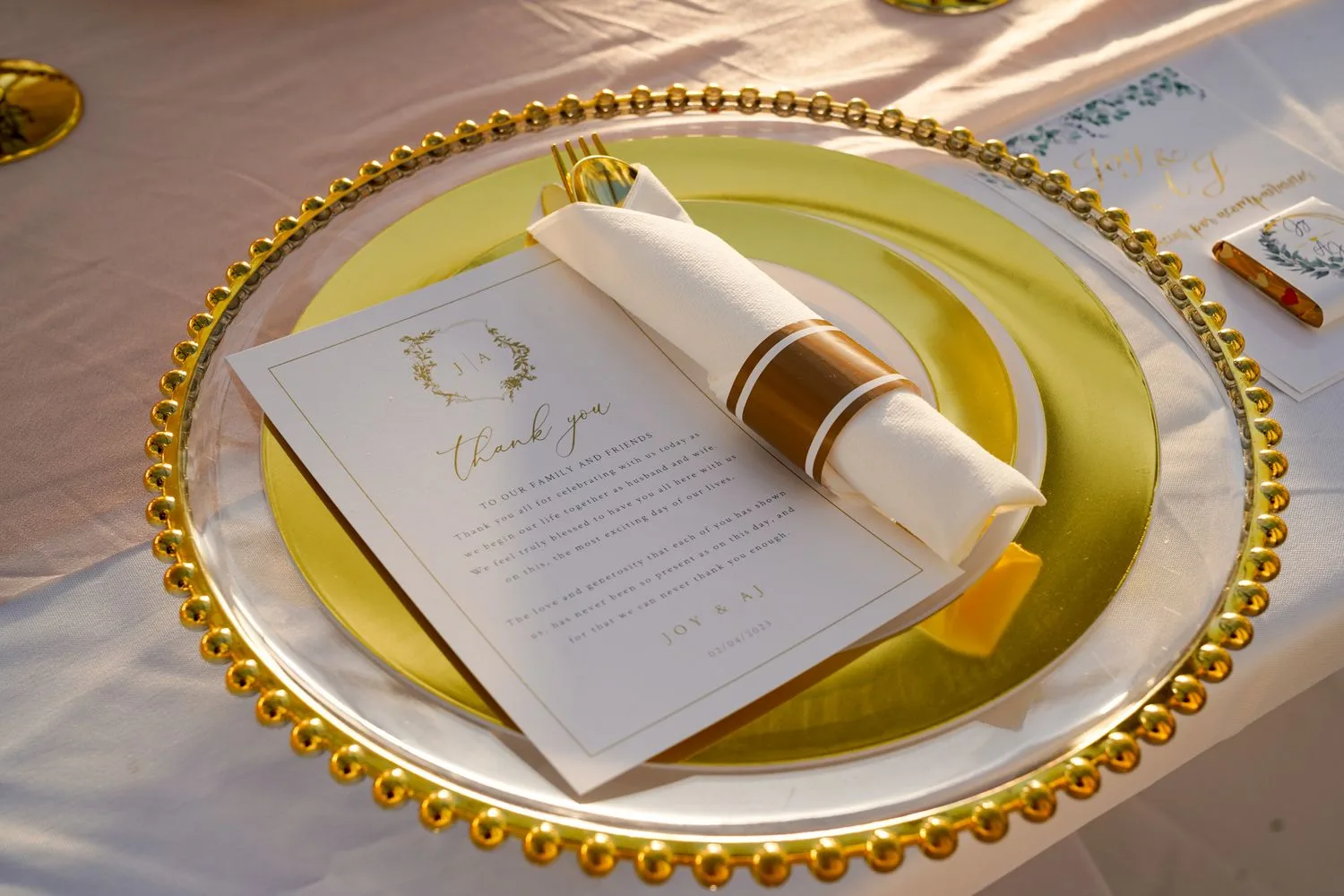 Gold-rimmed reception place setting with a thank-you card — Maximus Visions wedding photography, New Jersey & New York City