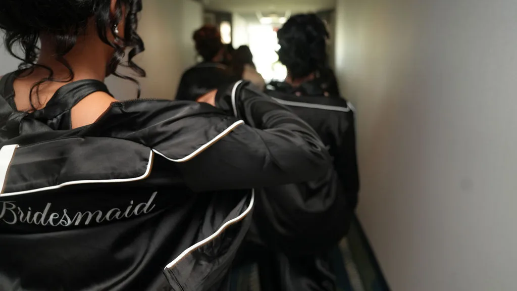 Black satin bridesmaid robes with white script embroidery — getting-ready detail, New Jersey wedding