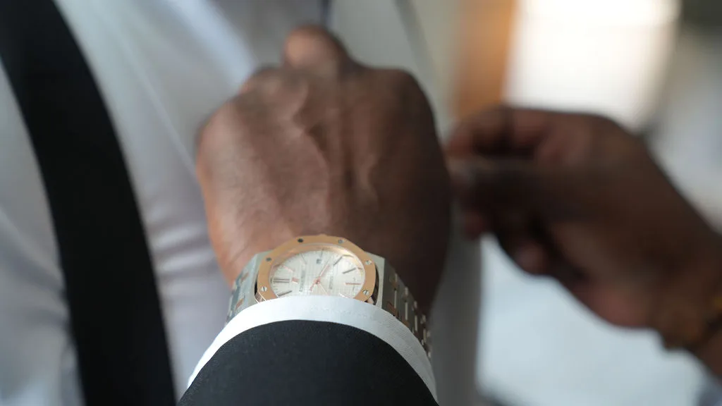 Gold watch on the wrist — wedding-morning detail from the groom's suite, New Jersey