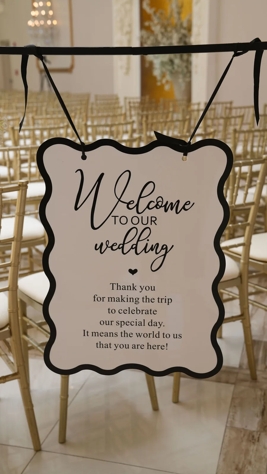 'Welcome to our wedding' sign hanging before rows of gold chiavari chairs in the ceremony room — New Jersey wedding detail by Maximus Visions