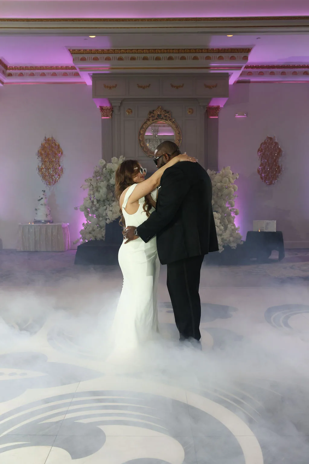 Becky and Tre share their first dance on a cloud of fog beneath pink uplighting — reception photography by Maximus Visions, New Jersey