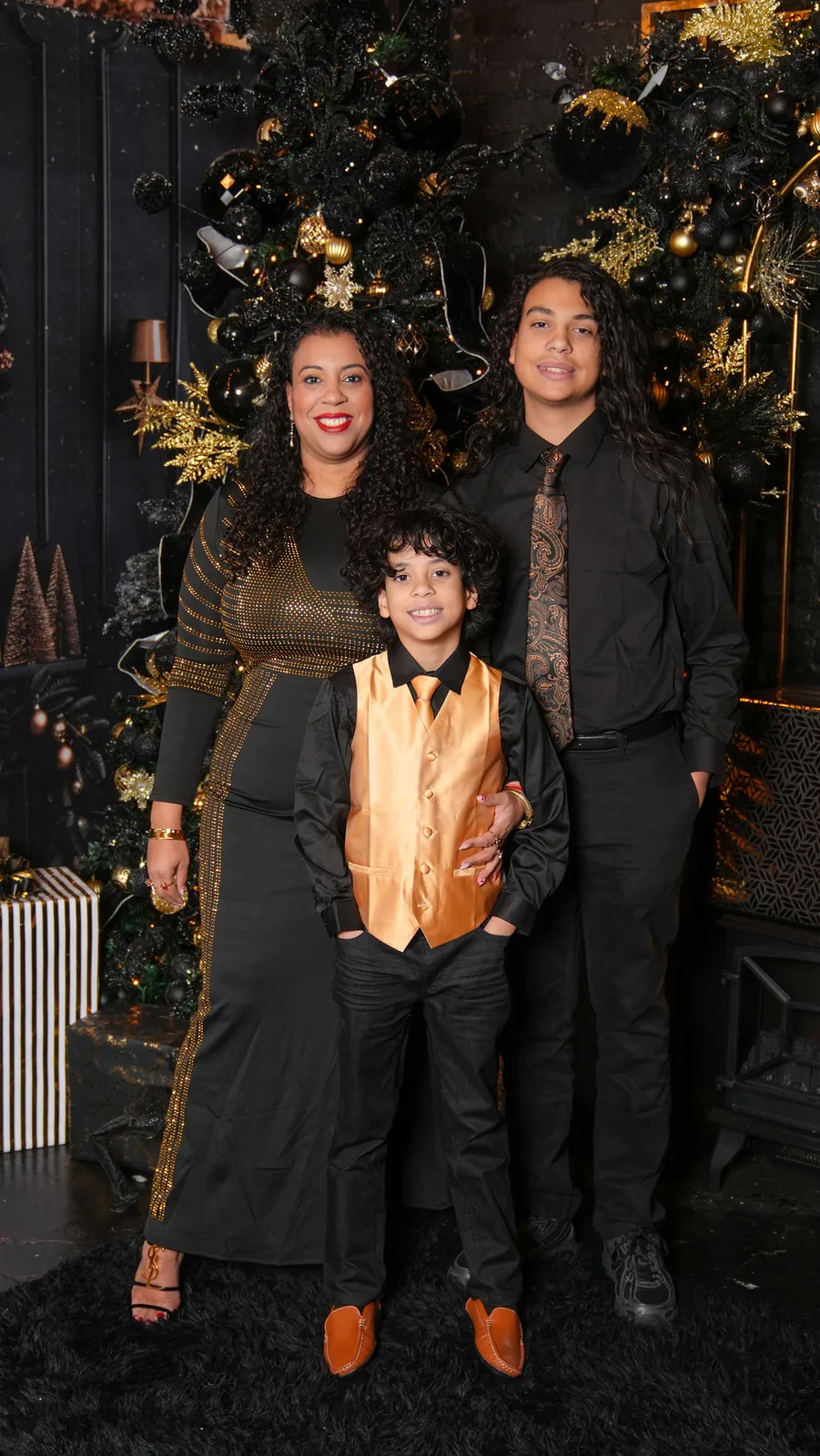 Mom with her two sons on the black-and-gold set — a gold vest, a paisley tie, and matching grins — Maximus Visions, New Jersey