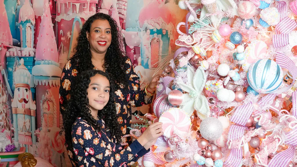 Mother and daughter decorate the pink candyland tree together — the closing frame of the Marlin family Christmas story by Maximus Visions, New Jersey