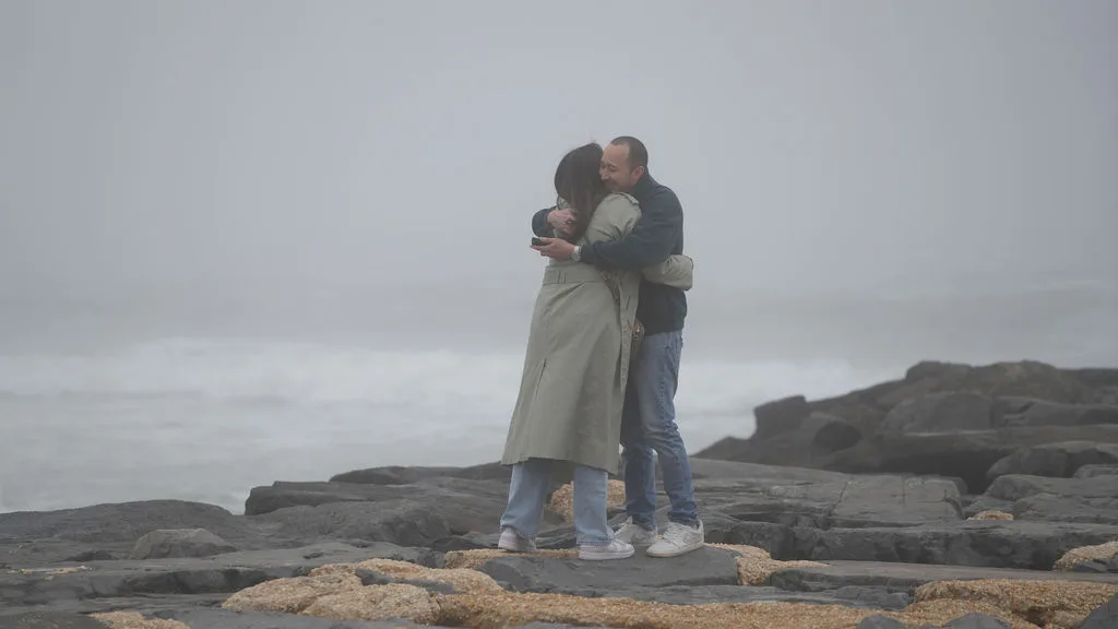 He holds her close, her arms around his neck — just-engaged embrace photographed by Maximus Visions, New Jersey