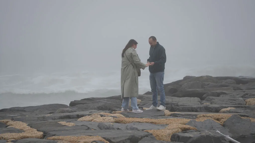 She admires the ring on her hand for the first time, out on the fog-covered jetty — New Jersey